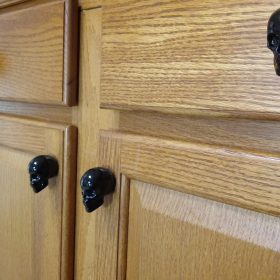 gothic cabinet knobs on a drawer with skull detailing